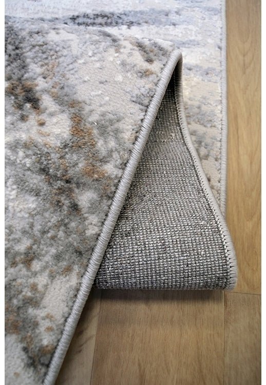 Abstract Burst Grey Rug by Surefit Carpets, close-up of textured grey rug with modern abstract pattern on soft fabric surface.