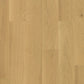 Quick-Step Cascada hardwood flooring planks with natural wood grain and warm brown tones, showcasing durable hard wood flooring.