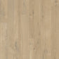 Quick-Step Impressive laminate flooring planks with a wood grain finish, showcasing a modern, durable flooring option.