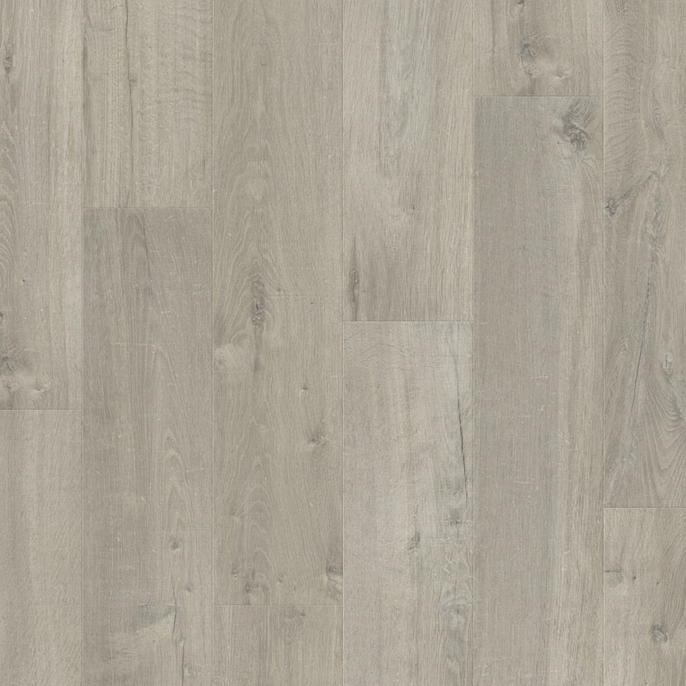 Quick-Step Impressive laminate flooring planks in a natural wood finish, showcasing the textured surface and realistic wood grain pattern.
