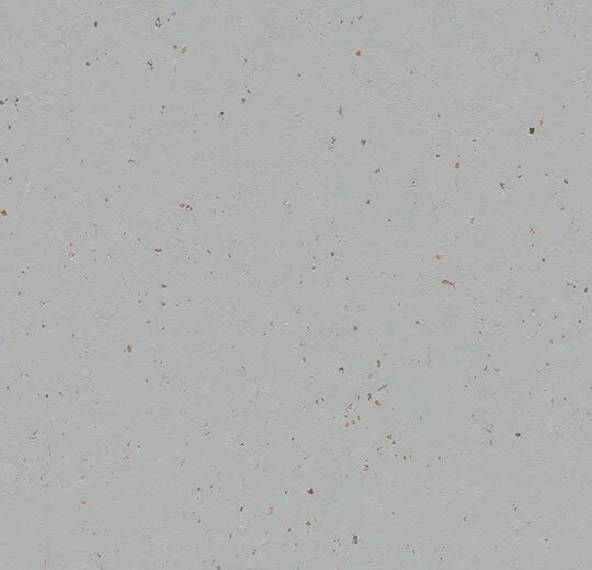 Forbo Marmoleum Solid Cocoa linoleum flooring plank with natural brown and beige tones, showcasing its textured surface and durable finish.