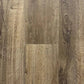 Spire Estyle Symphony Plank LVT flooring showing wood-like texture and natural oak finish in a close-up view.