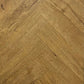 Spire Estyle Symphony Herringbone LVT flooring showing a close-up of herringbone pattern in warm wood tones