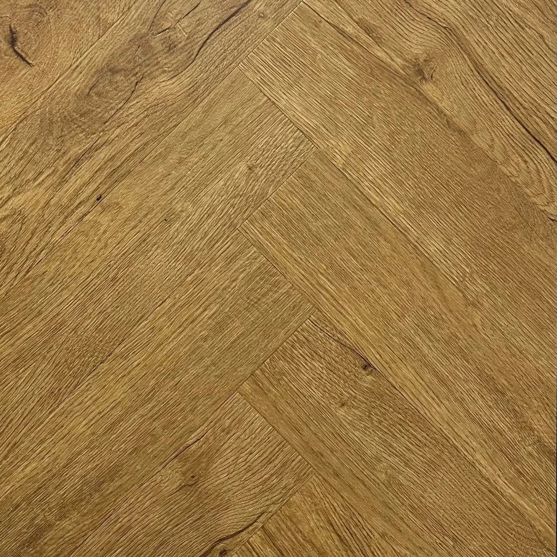 Spire Estyle Symphony Herringbone LVT flooring showing a close-up of herringbone pattern in warm wood tones