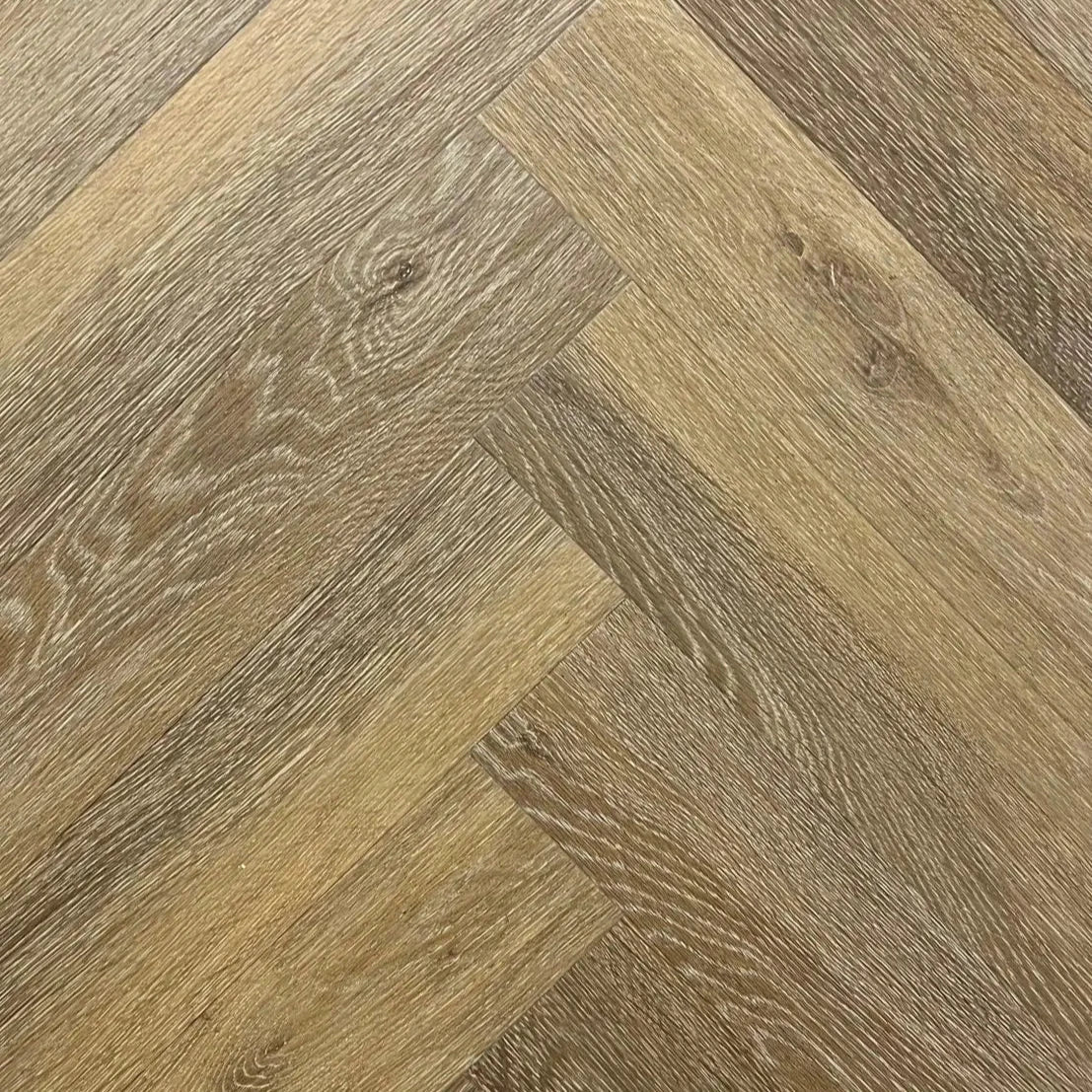 Spire Estyle Symphony Herringbone LVT flooring with wood-like pattern in a close-up view