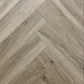 Spire Estyle Symphony Herringbone LVT flooring with a wood-like herringbone pattern, showcasing textured, realistic vinyl planks.