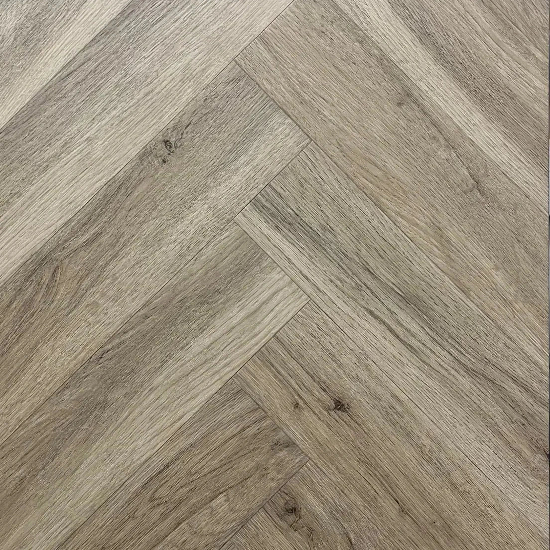 Spire Estyle Symphony Herringbone LVT flooring with a wood-like herringbone pattern, showcasing textured, realistic vinyl planks.