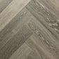 Spire Estyle Symphony Herringbone LVT flooring with wood-like pattern in a herringbone design, showcasing textured surface and warm tones.