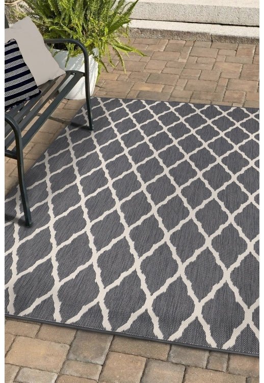 Surefit Carpets Alfresco Reverse Diamond Rug featuring a stylish geometric diamond pattern in neutral tones.