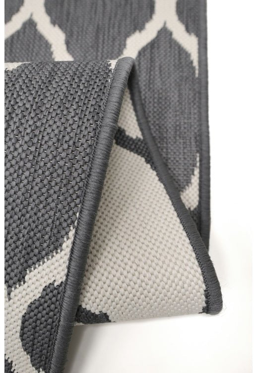 Surefit Carpets Alfresco Reverse Diamond Rug featuring a geometric pattern and textured design in neutral tones.