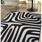 Surefit Carpets County Zebra Rug featuring a black and white zebra print design on soft, woven rug surface.