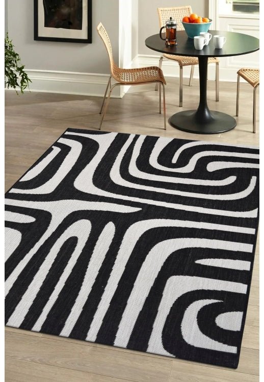 Surefit Carpets County Zebra Rug featuring a black and white zebra print design on soft, woven rug surface.