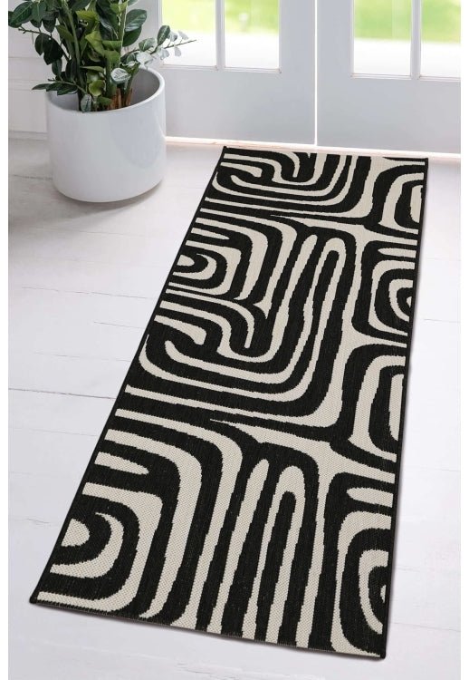 Surefit Carpets County Zebra Rug featuring a black and white zebra print design on soft woven fabric.