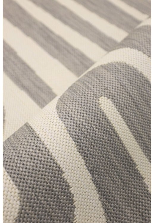 Surefit Carpets County Zebra Rug showcasing black and white zebra stripe pattern on soft woven material.