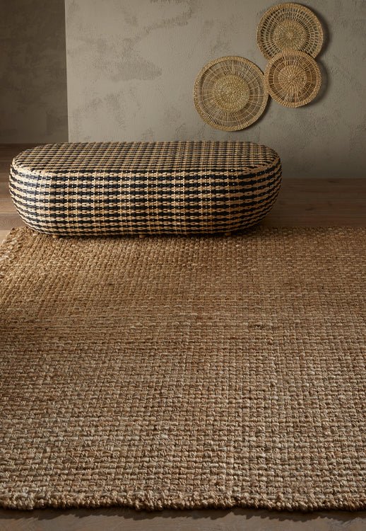 Surefit Carpets Naturals Basket Rug showing a woven, textured rug with a basket weave pattern in neutral tones.