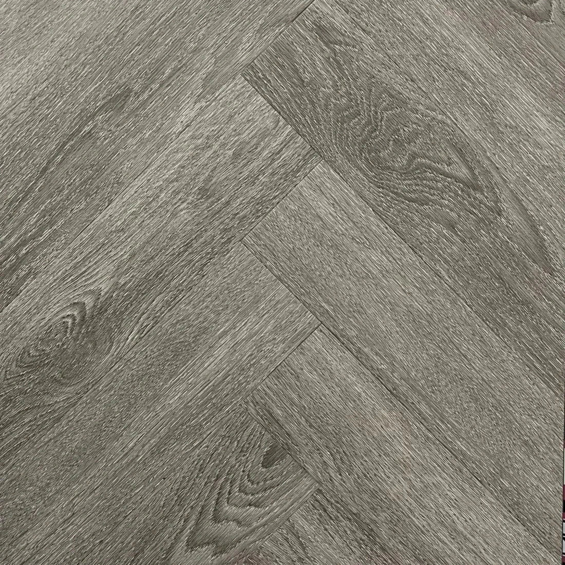 Spire Estyle Symphony Herringbone LVT flooring with a warm wood tone and intricate herringbone pattern, ideal for stylish interior design.